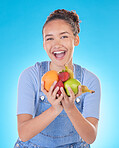 Happy, health and portrait of woman with fruit in studio for healthy eating, wellness and diet. Food, lose weight and female person on blue background with apple, orange and banana for nutrition