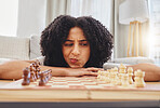 Chess, thinking and portrait of woman with board for strategy, problem solving and challenge at home. Competition, ideas and female person with chessboard in living room ready for playing games