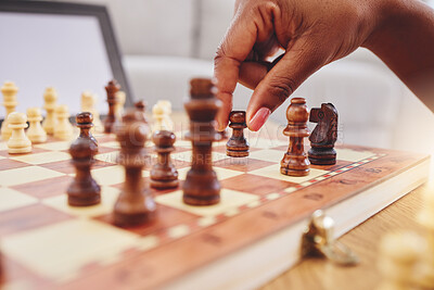 Buy stock photo Chess, move and closeup of hand with board piece for strategy, thinking and challenge on table. Competition, planning and zoom of hands of person with chessboard in living room for problem solving