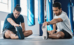 Men, gym and legs stretching of friends before training, fitness and workout in health club. Warmup, athlete and man ready to start sport exercise together on the floor with personal trainer class