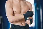 Sports, boxing and man wrap hands in gym for training, workout and exercise for mma fighting. Fitness, body builder and stomach of male athlete ready for boxer competition, practice and performance