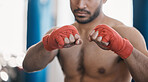 Sports, boxing and hands of man punch in gym for training, workout and exercise for mma fight. Fitness, body builder and closeup of male athlete ready for boxer competition, practice and performance