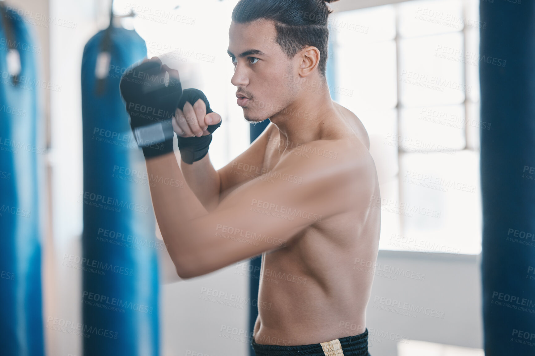 Buy stock photo Sports, boxing and man punch for mma fight in gym for training, workout and martial arts exercise. Fitness, body builder and serious male athlete ready for boxer competition, practice and performance
