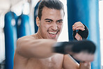 Sports, boxing and man punch in gym for training, workout and exercise for mma fighting. Fitness, body builder and face of male athlete ready for boxer competition, practice and martial arts match