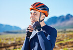 Mountain, helmet and face of man cycling for fitness, training or competition or sports adventure with blue sky. Gear, athlete and safety in outdoor cycle, bike ride or exercise in nature or park