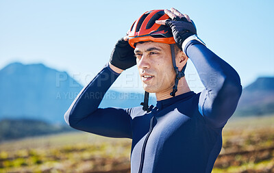 Buy stock photo Mountain, helmet and man cycling in a marathon, fitness training or competition or sports adventure with blue sky. Gear, athlete and safety in outdoor cycle, bike ride or exercise in nature or park