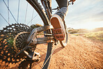 Summer, cycling and a man on a bike and dirt road for fitness, morning cardio or adventure in nature. Sports, feet and a person on a bicycle for a race, competition or exercise in the countryside