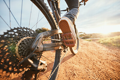 Buy stock photo Summer, cycling and a man on a bike and dirt road for fitness, morning cardio or adventure in nature. Sports, feet and a person on a bicycle for a race, competition or exercise in the countryside