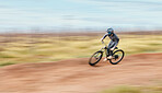 Sports, blur and man riding a bike in nature training for a race, marathon or competition. Fitness, motion and male athlete biker practicing for an outdoor cardio exercise, adventure or workout.