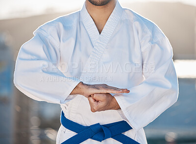 Buy stock photo Karate, fitness and respect with a sports man in gi, training in the city on a blurred background. Exercise, discipline or fight with a male athlete during a self defense workout for health closeup