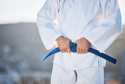 Buy stock photo Karate, exercise and fighting with a sports man in gi, training in the city on a blurred background. Fitness, discipline or strong with a male athlete during a self defense workout for health closeup