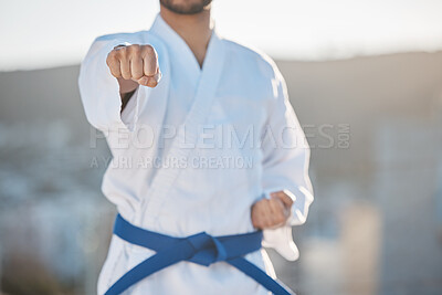 Buy stock photo Karate, fitness and fighting with a sports man in gi, training in the city on a blurred background. Exercise, discipline or strong with a male athlete during a self defense workout for health closeup
