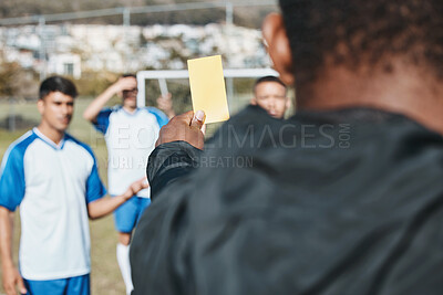 Buy stock photo Sports team, yellow card and soccer referee outdoor on field for competition or game foul or rules. Football player, athlete club and person with paper in hand for warning, penalty or punishment