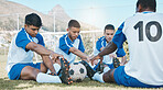 Sports group, soccer and team stretching legs on field for fitness training or exercise outdoor. Football player, club and diversity athlete men with focus on sport competition, workout or warm up