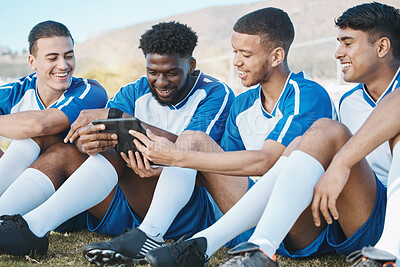 Buy stock photo Soccer player, team or group with a tablet outdoor on field for fitness training or online game. Football, club and diversity athlete people or friends with tech to watch sports competition or video