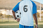 Sports, soccer ball and man with player number on a field for exercise, fitness and training outdoor. Football club, pitch and game with back of athlete person for professional sport competition
