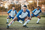 Sports group, soccer and team stretching on field for fitness training or game outdoor. Football player, club and athlete people with focus for sport competition, legs workout or warm up challenge