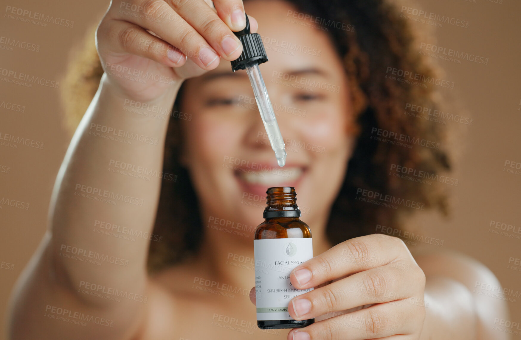 Buy stock photo Skincare, beauty or hands of woman with serum in studio for a natural glow, wellness or cosmetic routine. Bottle closeup, product or model with facial oil in dermatology treatment on brown background