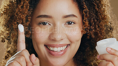 Buy stock photo Black woman, skincare and cream on hand or face for dermatology, beauty or happiness in salon or studio. Skin, care and happy portrait with cosmetics, lotion or sunscreen for wellness and confidence