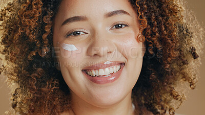 Buy stock photo Skincare, black woman and cream on face for dermatology, beauty or happiness on brown background in studio. Skin, care or happy portrait with cosmetics, lotion or sunscreen for wellness or confidence