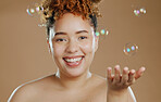 Black woman, face and blowing kiss with smile for skincare, self love or care against a brown studio background. Portrait of happy African American female smiling in satisfaction for beauty