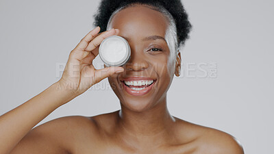 Buy stock photo Happy black woman, portrait and face cream for skincare, beauty or cosmetics against a studio background. African female person or model smile with moisturizer, creme or lotion for facial treatment