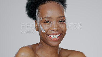 Buy stock photo Black woman, face and cream with beauty, skincare and healthy skin for portrait, moisturizer and blue studio background. Happy, female and sunscreen for dermatology, cosmetology and luxury product