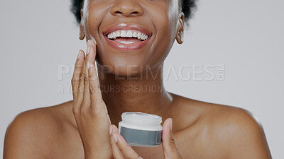 Buy stock photo Black Woman, face cream and skincare with beauty, facial and cosmetic product in container, studio background and smile. Happy, female and healthy skin with moisturizer, cosmetology and dermatology 