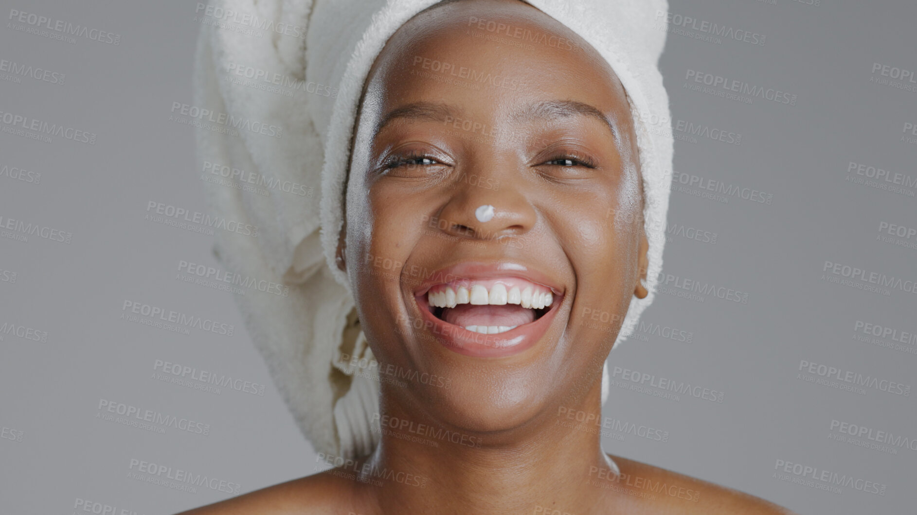 Buy stock photo Portrait, cream and laughing with a happy black woman in studio on a gray background for natural wellness. Face, funny and lotion with a happy young model closeup to apply treatment to her skin