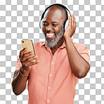 One mature african american man listening to music using wireless headphones while isolated on a png background. Happy man with a grey beard smiling while streaming on his phone in studio