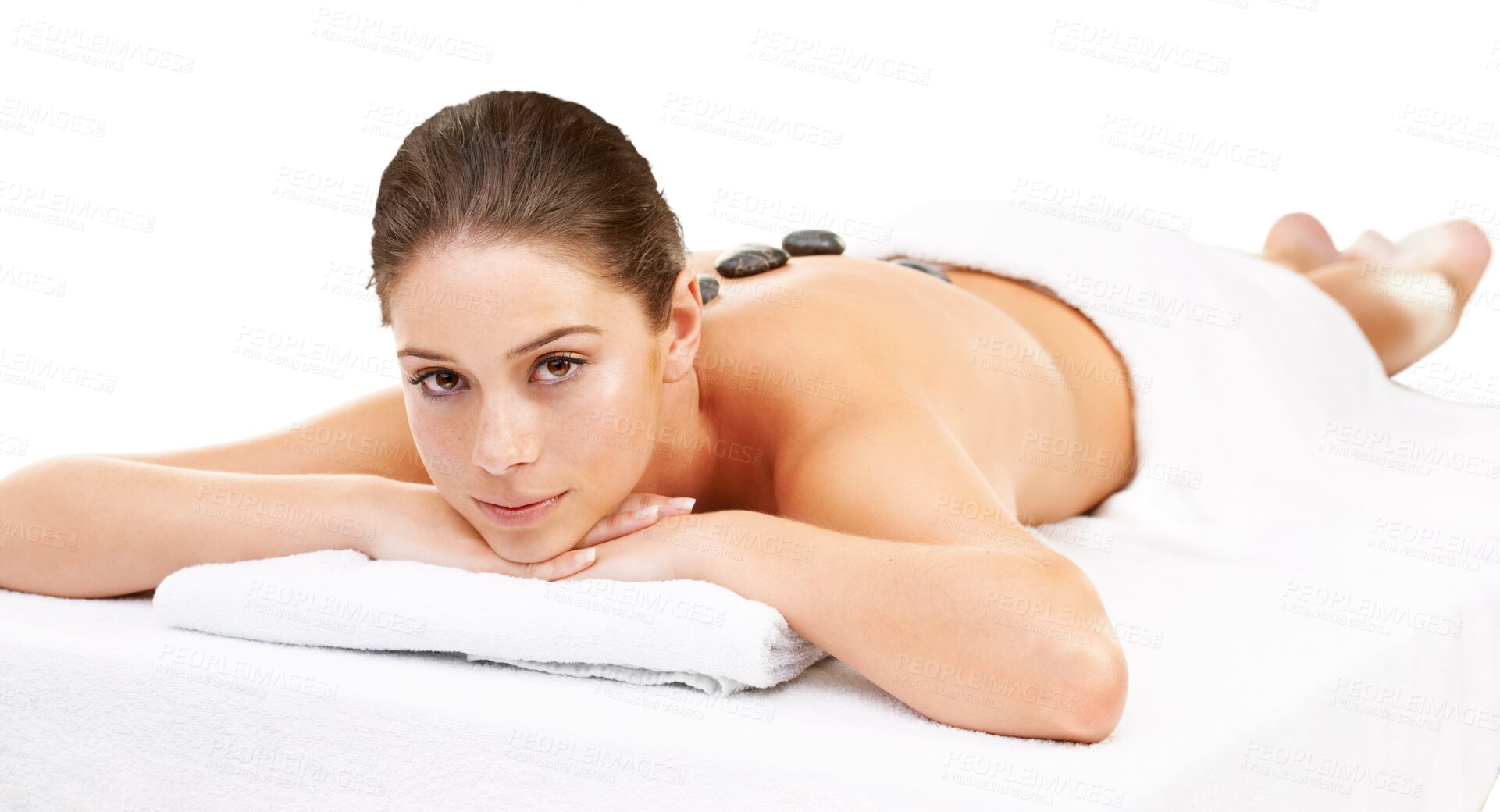 Buy stock photo Woman, portrait and massage with skincare, hot stone and body at wellness center. Young female person, relax and massage bed with cosmetics care treatment isolated on transparent, png background