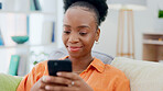 Cellphone, communication and black woman on a sofa typing a text message while relaxing in her living room. Technology, chat and African female networking on social media or mobile app with a phone.