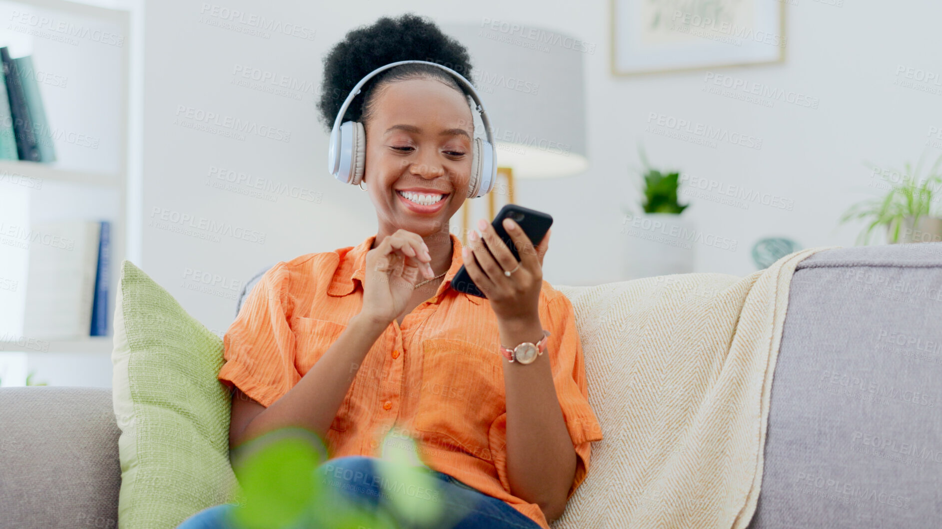 Buy stock photo Headphones, black woman or phone for music streaming for mental health, wellness or happiness. Smile, social media post or excited African person on sofa listening to audio technology on mobile app