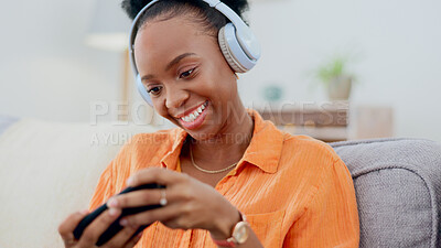 Buy stock photo Smartphone games, headphones or woman in home on sofa for playing online subscription, digital gaming or connection. Happy african person, video game or mobile in living room for streaming multimedia