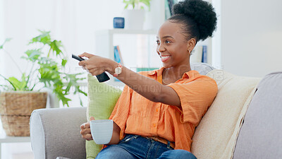 Buy stock photo Woman, coffee and remote of tv on sofa at home to watch subscription, cable show and movies. Happy african person, drinking tea and relax in living room for television, multimedia broadcast and film