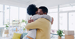 Love, happy and black couple hug in lounge, cheerful and bonding with joy, loving together and romance. Romantic, man and woman embrace, relationship and reunion in living room, marriage and smile