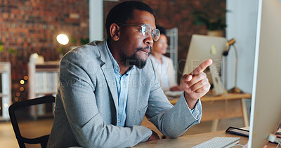 Buy stock photo Computer, pointing and a black man in an office, reading and technology for research, website and information. Employee, consultant and African agent in workplace and email check on a pc at night