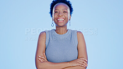 Buy stock photo Smile, crossed arms and portrait of black woman in a studio with positive, confident and good attitude. Happy, pride and young African female model with joy and happiness isolated by blue background.