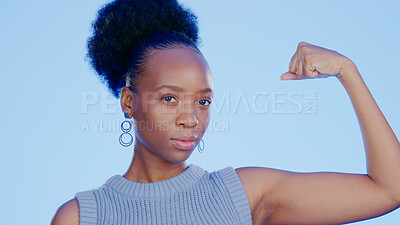 Buy stock photo Strong, muscle and face of a black woman with biceps isolated on a blue background in a studio. Serious, confident and portrait of an African girl with power, empowerment and showing gym progress