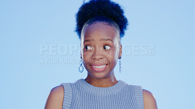 Buy stock photo Guilt, embarrassed and awkward with a black woman in studio on a blue background feeling nervous. Thinking, idea and worried with a young feeling looking insecure or anxious about a mistake