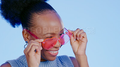 Buy stock photo Fun, sunglasses and smile, black woman in studio with cool, trendy summer fashion and creative mockup. Happiness, luxury eyewear and excited model with designer frame on blue background for eye care.