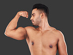 Muscle, arm and man strong from training for health, goal and body against a grey mockup studio background. Power, pride and athlete with bicep to show progress with workout, exercise and fitness