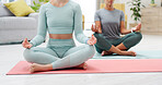 Lotus, morning meditation and women in a living room, calm mindfulness and balance on the floor. Fitness, wellness and friends sitting together for spiritual training, stress relief and zen exercise