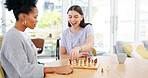 checkmate with the winner laughing and thinking about plan. Diversity women together at table in room happy about competition move and strategy to win on chessboard