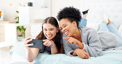 Buy stock photo Phone, happy and girl friends on a bed for relaxing, bonding and watching a funny, comic or comedy video. Smile, laugh and young women scroll on social media, mobile app or the internet in bedroom.