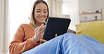 Woman, home and tablet on home sofa with internet connection for streaming video or movie online. Asian female happy, relax and laughing or scrolling on social media or mobile app for communication