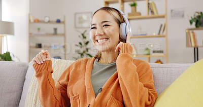 Buy stock photo Dance, music and an asian woman on a sofa in the living room of her home to relax while streaming audio. Smile, freedom and wellness with a young person listening to the radio in her apartment