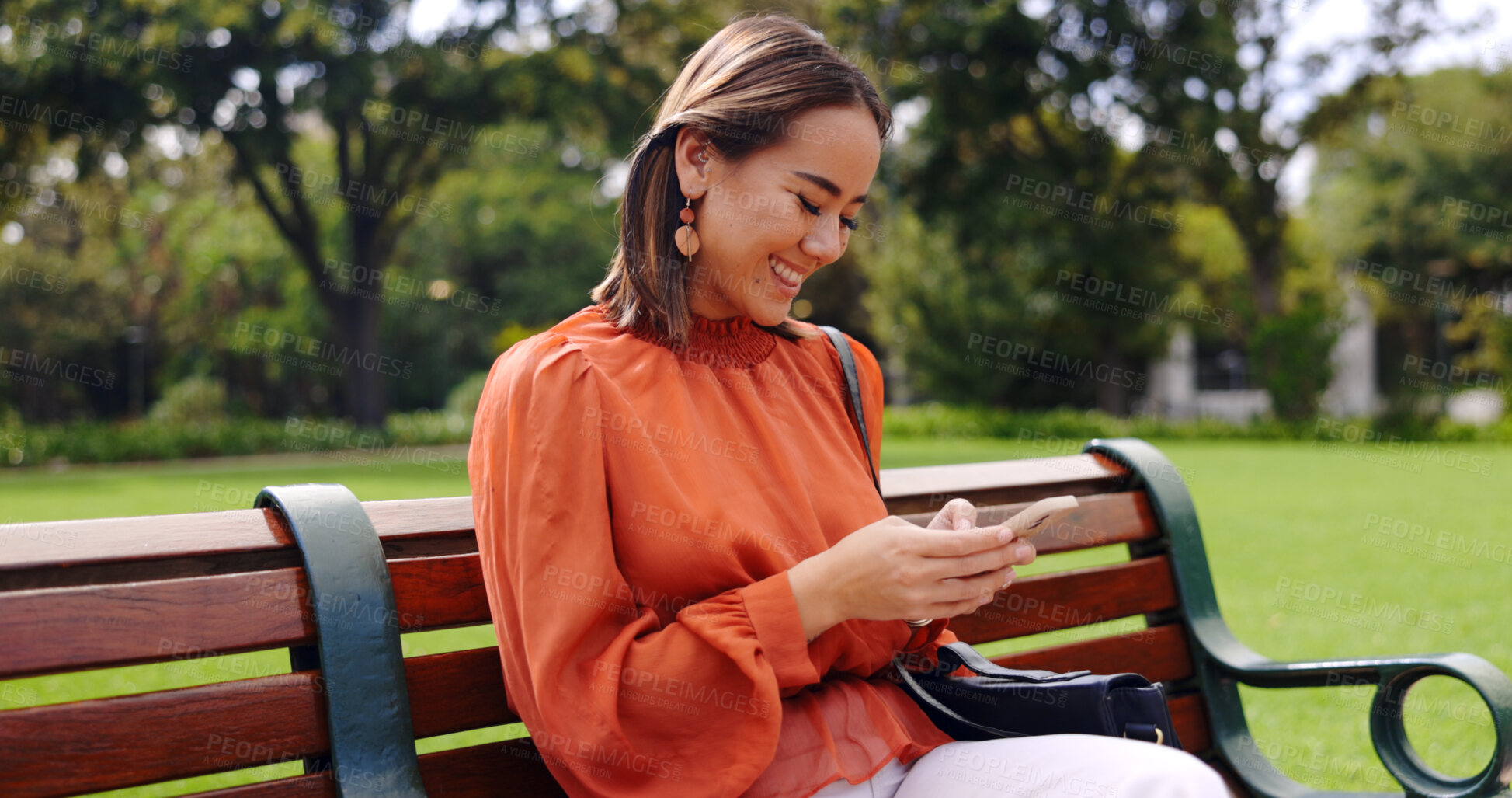 Buy stock photo Happy asian woman, phone and park bench for social media, communication or outdoor networking. Female person smile in relax with mobile smartphone app for online chatting, texting or search in nature