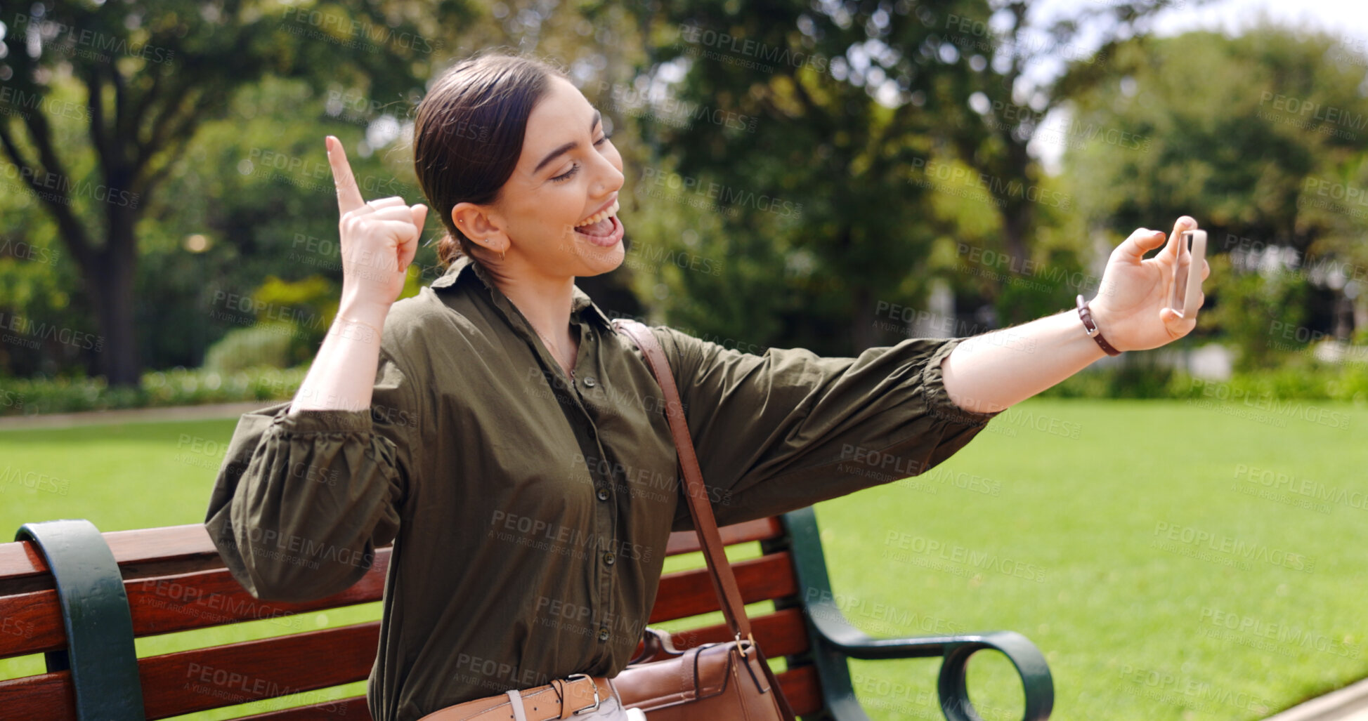 Buy stock photo Excited, selfie and woman at park on bench outdoor, hand gesture and smile. Photography, picture and happy person in nature for social media post on internet, funny and influencer laugh in garden