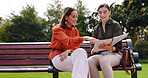 Park, professional women and bench with paperwork and document planning for creative project. Share ideas, collaboration and female worker talking with notebook plan and brainstorming outdoor